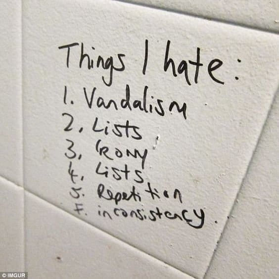 Bathroom tile graffiti listing things I hate, including lists, irony and repetition.