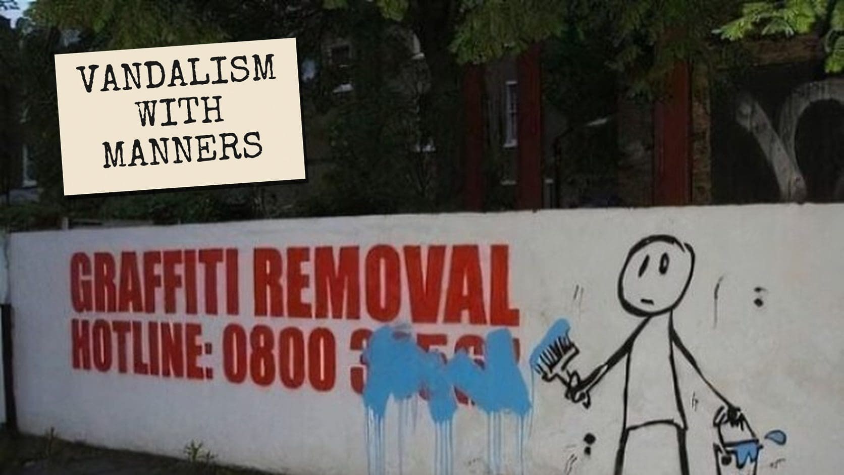 A graffiti removal hotline sign painted over by a stick figure with a brush, a classic piece of thoughtful graffiti.