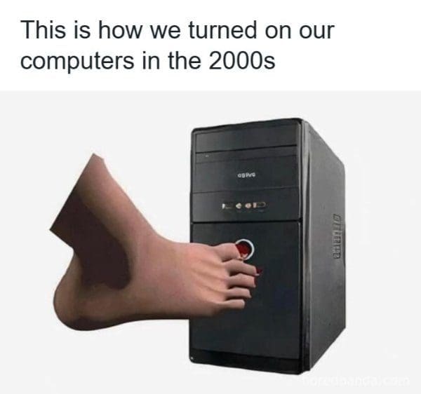 Bare foot pressing a desktop computer power button with its big toe.