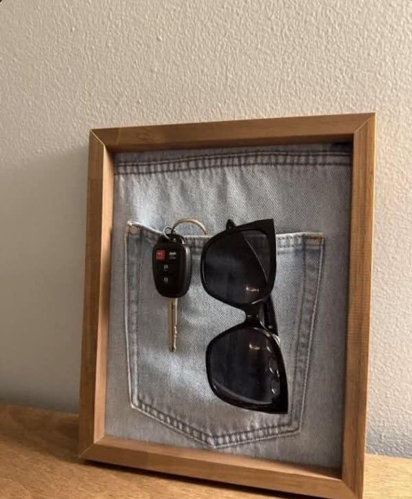 Framed jeans back pocket on a shelf holding car keys and sunglasses, one of the unique designs.