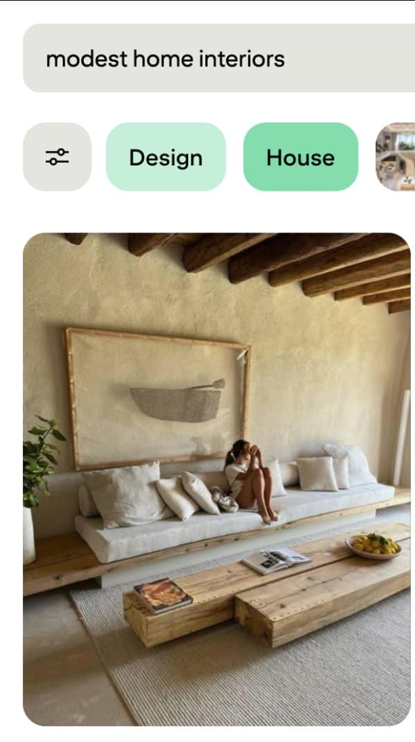 Modest home interiors search showing unique designs: plaster walls, exposed beams and a long low sofa.
