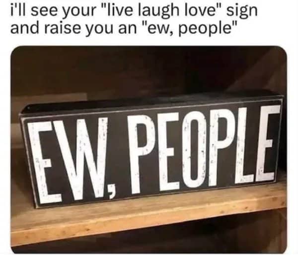 Black wooden sign that says ew, people sitting on a shelf