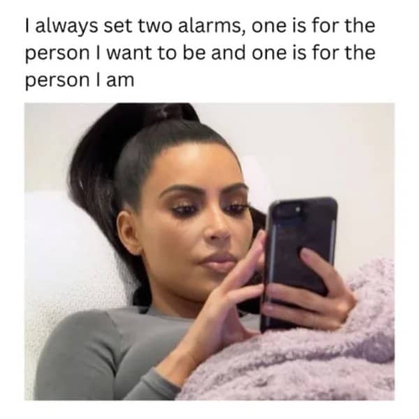 Kim Kardashian looking at her phone below a joke about setting two alarms