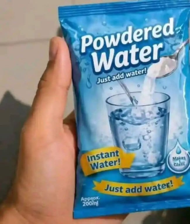 Hand holding a packet of powdered water with instructions that say just add water.