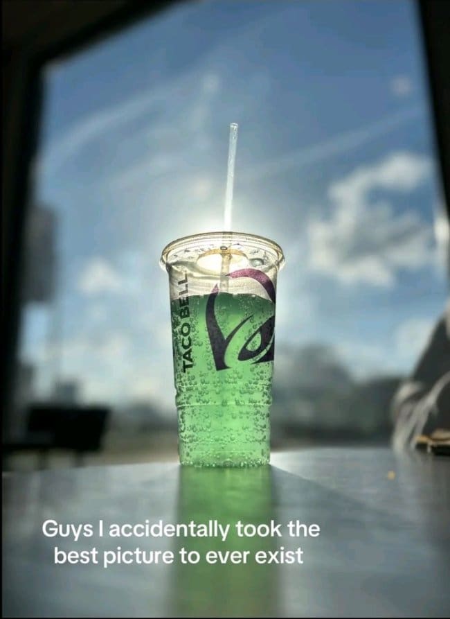 Green Taco Bell fountain soda glowing in sunlight, praised as an accidental photography masterpiece.