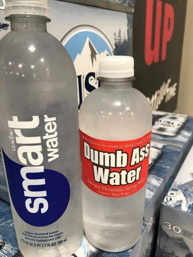 Bottle of smartwater beside a bottle humorously labeled Dumb Ass Water from Georgia.