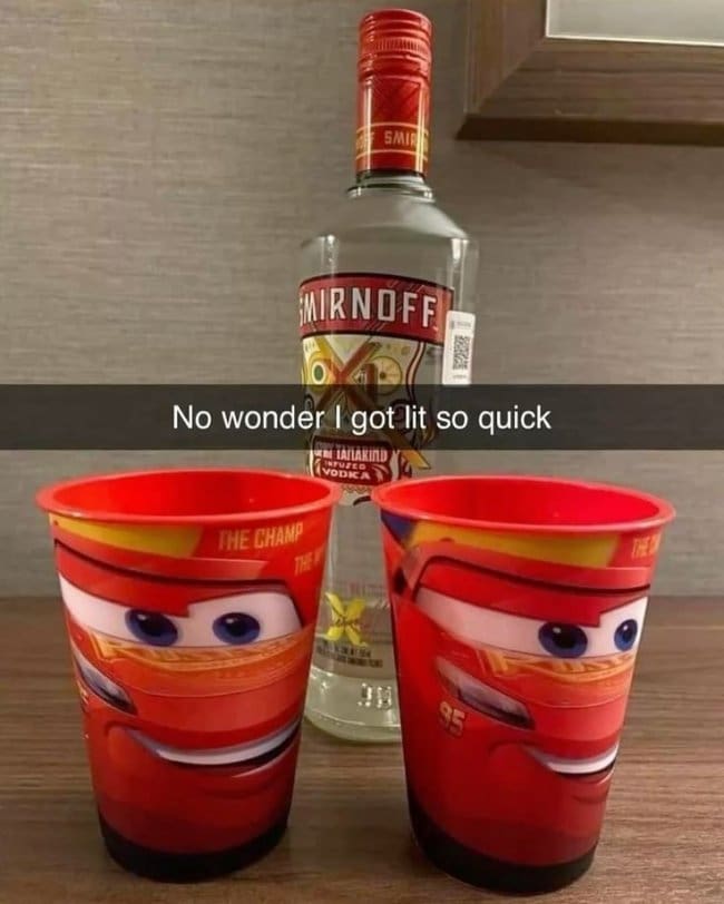 Smirnoff vodka bottle behind two Lightning McQueen children's cups, joking about getting drunk fast.