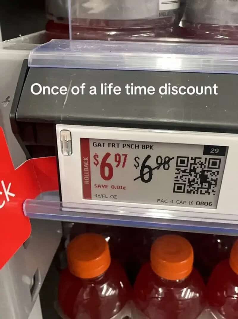 Store price tag showing a rollback from 6.98 to 6.97, saving one cent on fruit punch.