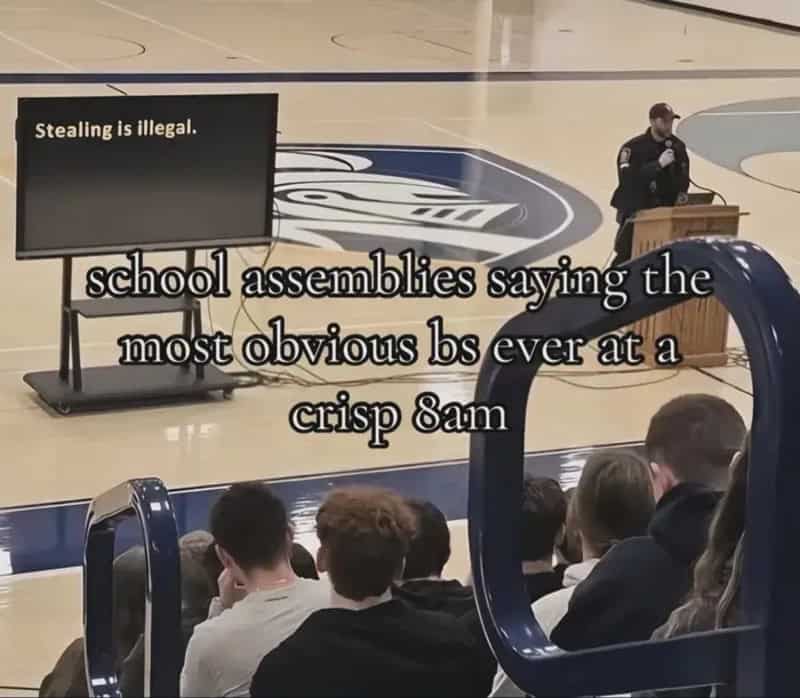 School assembly where an officer presents a slide reading stealing is illegal to students.