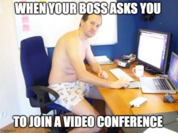 Man in his underwear at an office desk when the boss asks him to join a video conference.