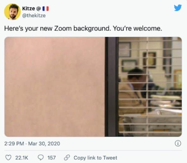 Tweet offering a photo of a blank office wall as everyone's new Zoom background.