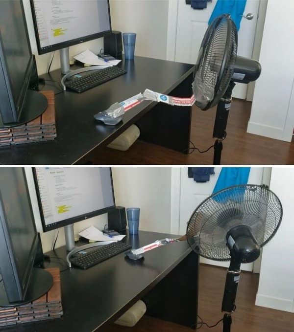 Oscillating fan rigged to nudge a computer mouse, a work from home memes classic about staying online.