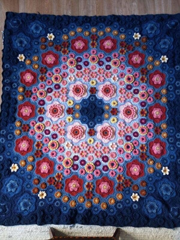 Colorful floral mandala crochet blanket on floor
