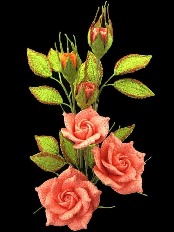 Crocheted bouquet of pink roses and green leaves