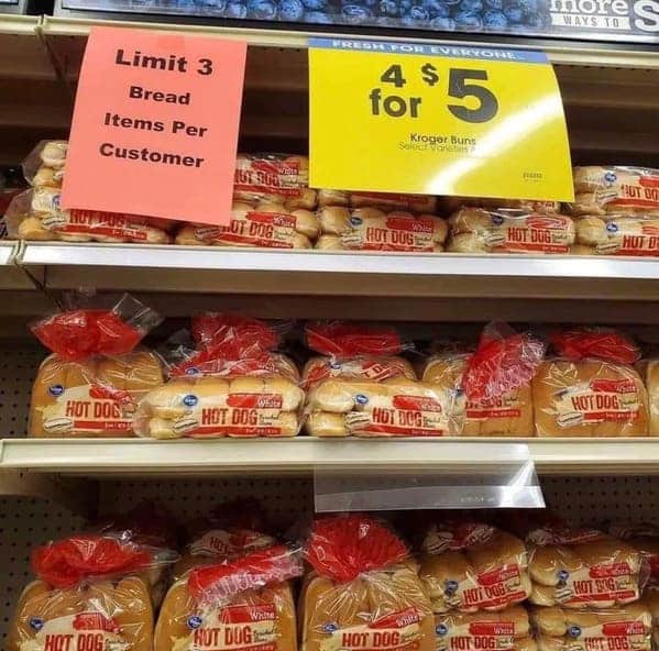 A grocery store math fail with conflicting signs for a sale and item limits.
