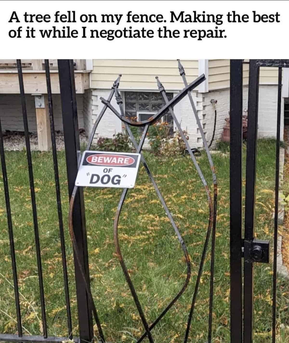 Bent fence with "Beware of 'Dog'" sign humorously repurposed