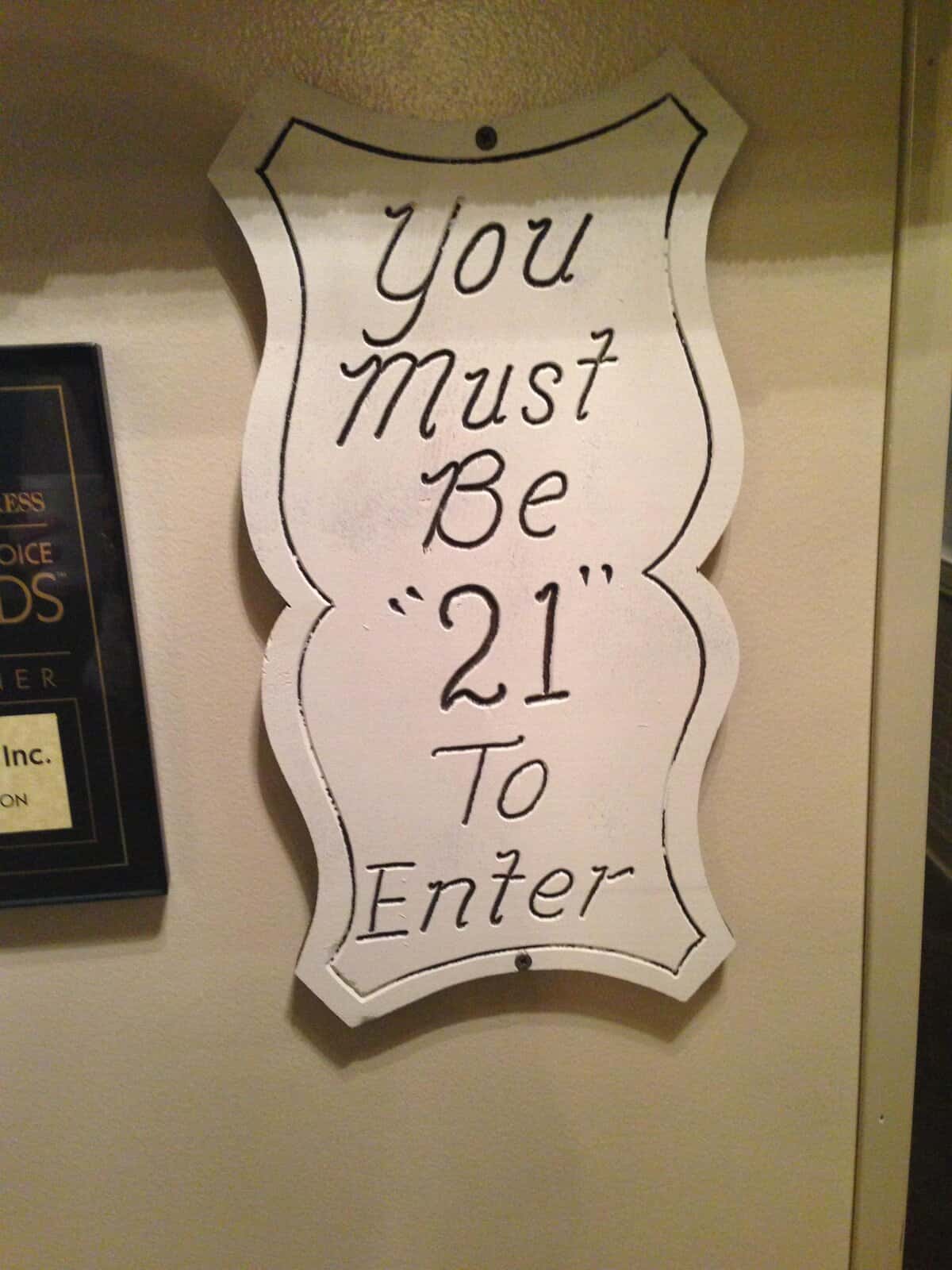 Entrance sign stating “You Must Be ‘21’ To Enter”