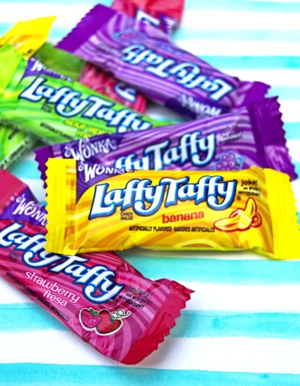 Colorful wrappers for various flavors of Wonka Laffy Taffy, a chewy 80s candy with jokes.