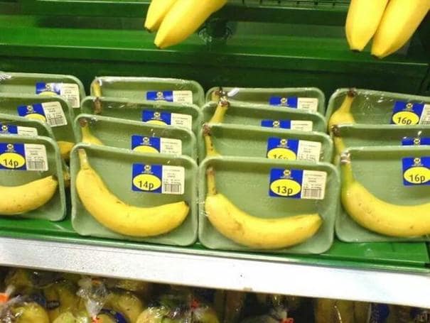 A product packaging fail of single bananas wrapped in plastic foam trays.