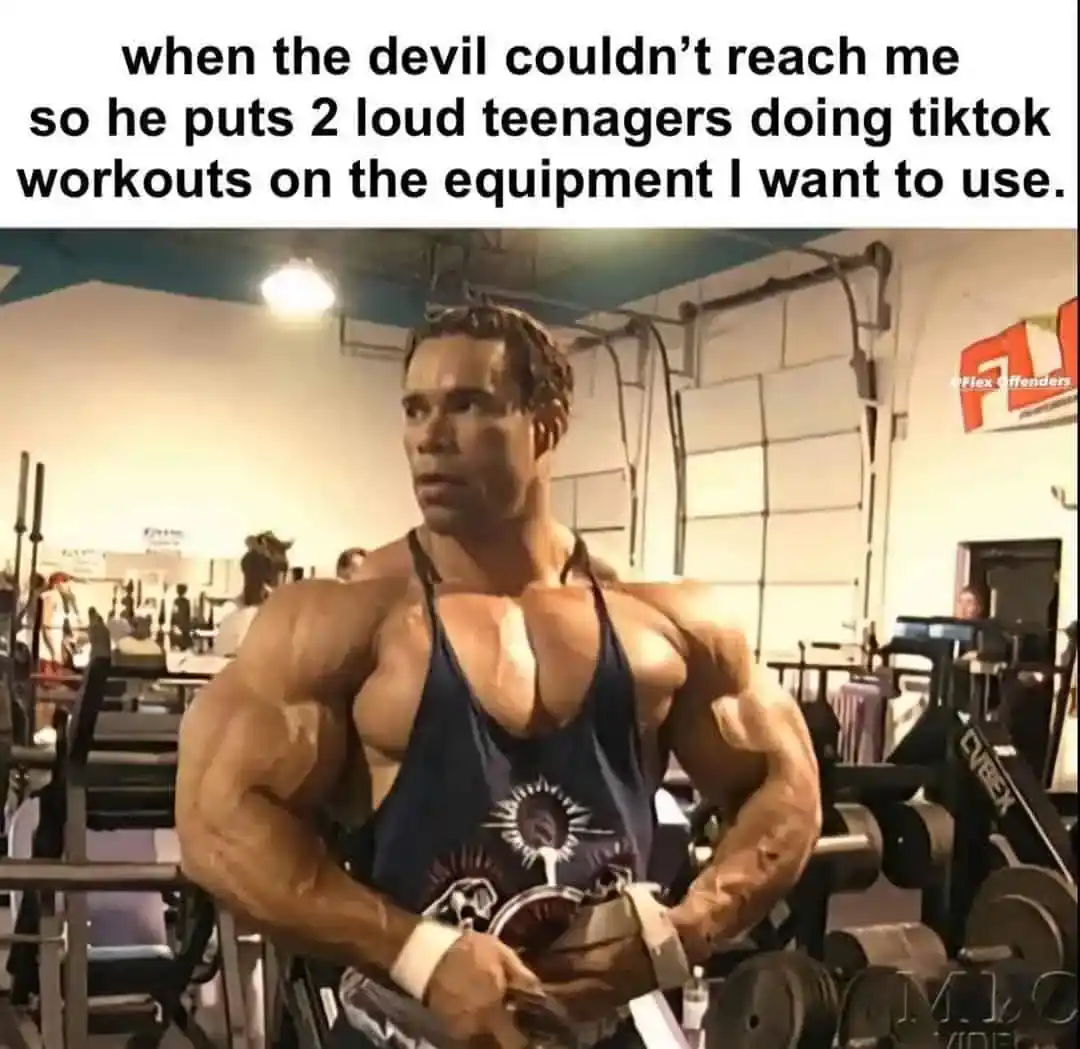 A gym meme of a bodybuilder looking annoyed by teenagers filming TikToks on equipment.