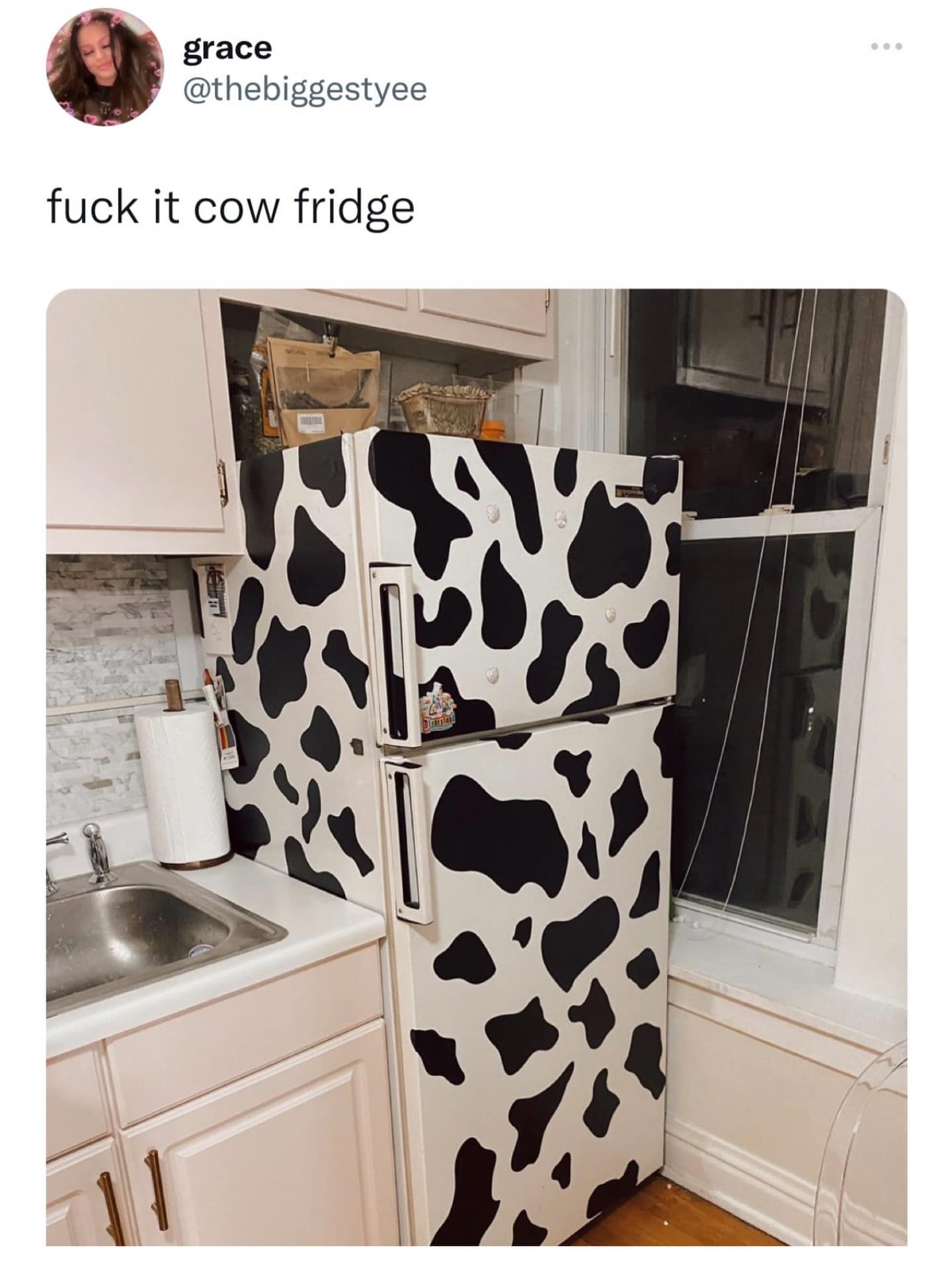 A funny meme photo of a refrigerator painted with a cow print captioned fuck it cow fridge.