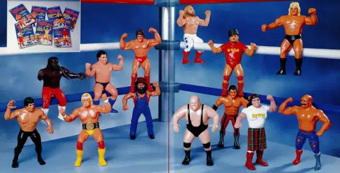 A collection of vintage WWF wrestling action figures including Hulk Hogan and Andre the Giant in a ring.