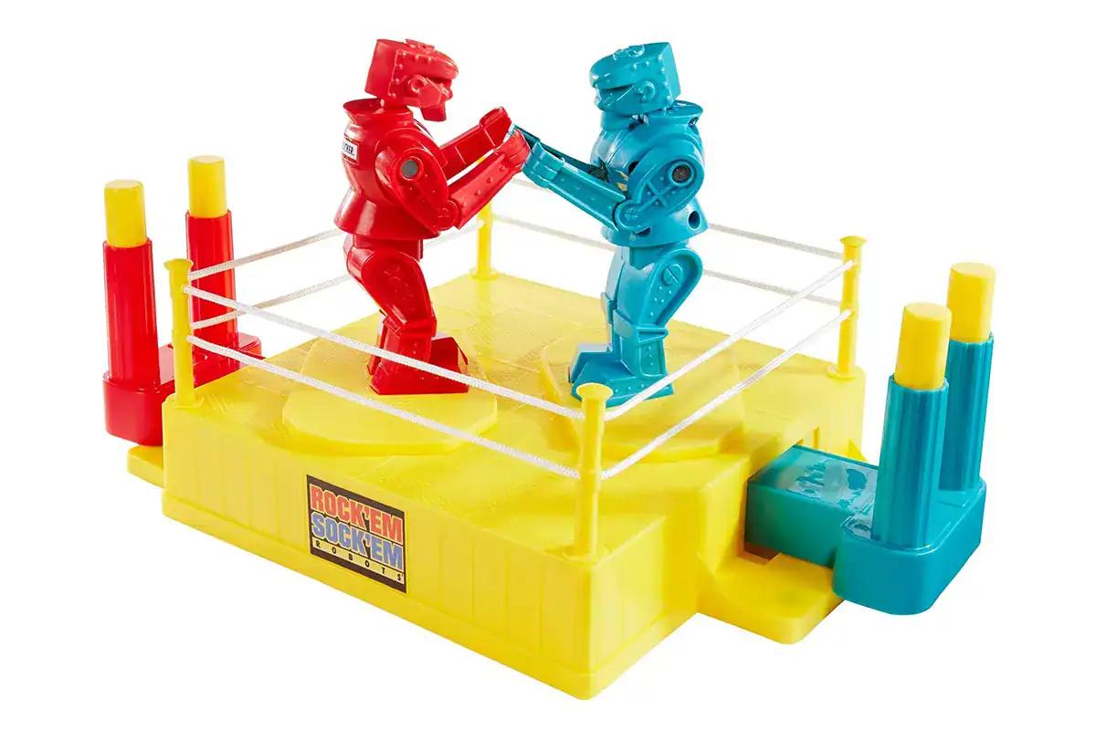 A close up of the classic Rock Em Sock Em Robots game with red and blue robots in a yellow ring.