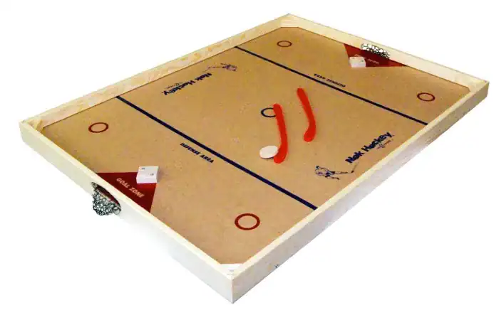 A wooden Nok Hockey board game with red and blue lines and wooden pucks.