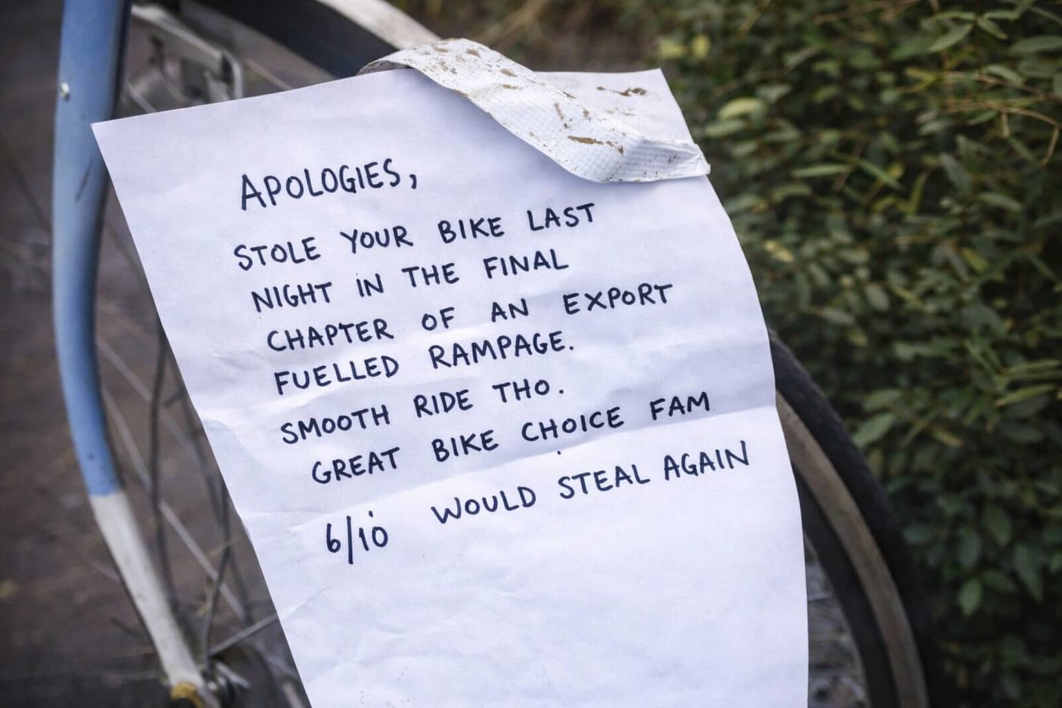Funny apology notes written on paper attached to a bicycle mentioning an export fueled rampage.