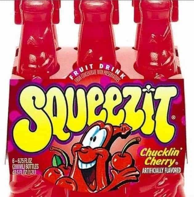 A six-pack of Squeezit bottles in Chucklin' Cherry flavor, a definitive nostalgic drink for 90s kids who loved squeezing the plastic bottles.