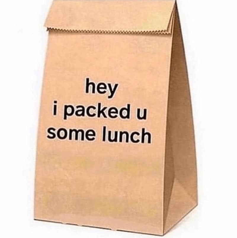 relationship meme featuring a plain brown paper lunch bag standing alone. Simple black text printed on the bag reads: "hey i packed u some lunch," representing small, daily acts of service in a partnership.