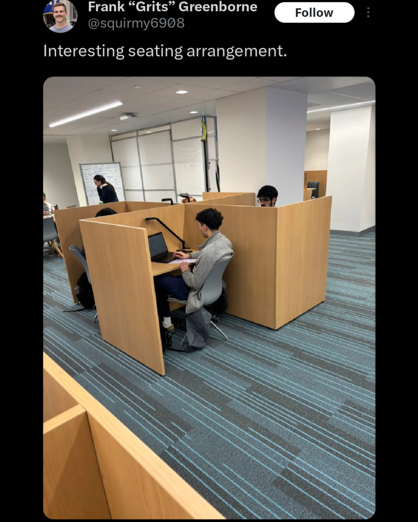 Photo of office cubicles arranged in a shape resembling a swastika with a sarcastic caption.