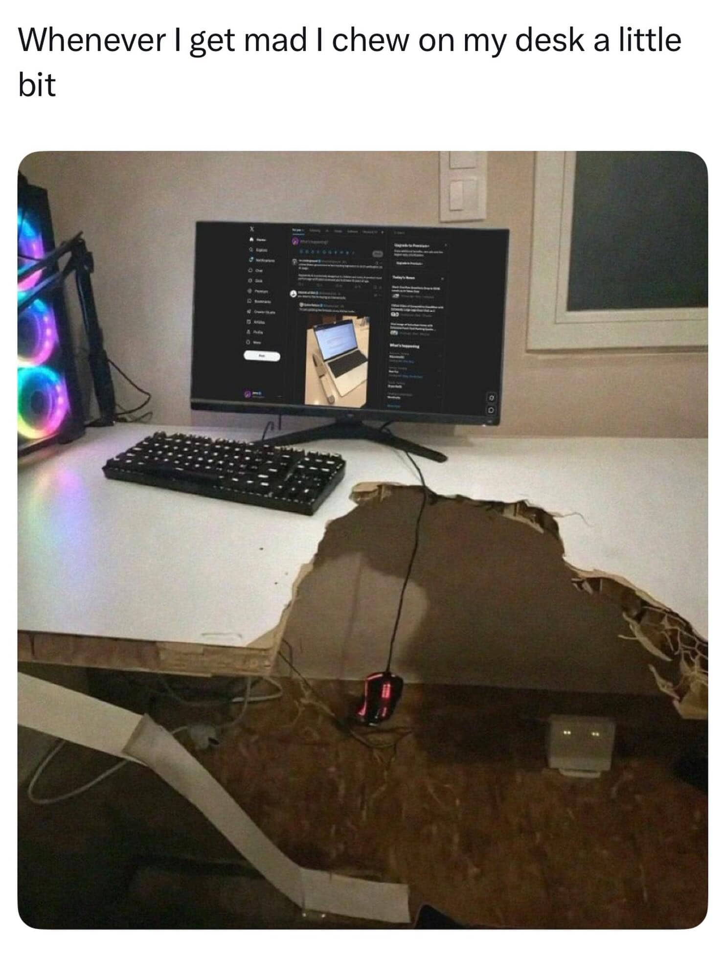 Funny gaming meme showing a computer desk with a massive chunk missing, captioned about chewing the desk.
