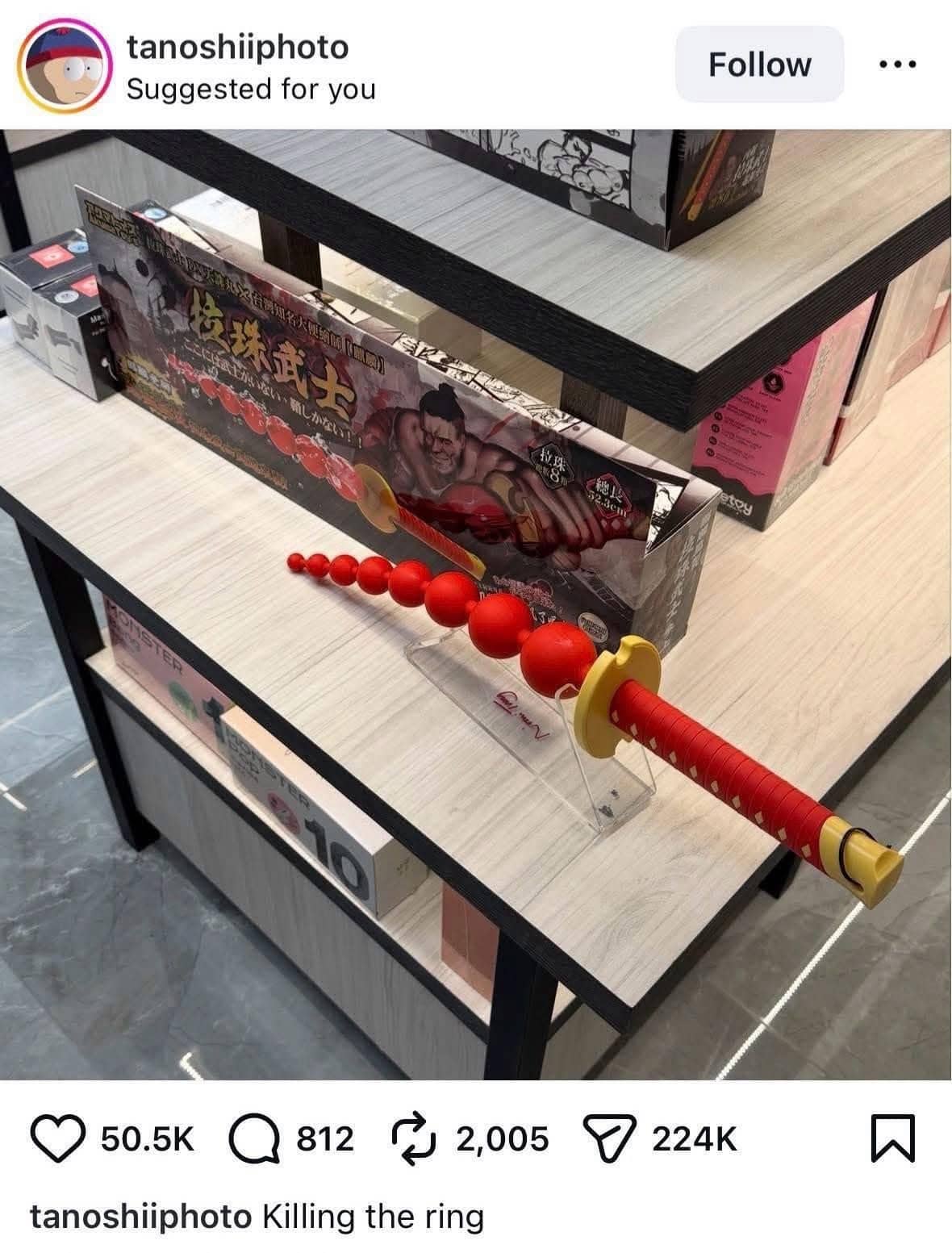 Instagram post showing a bizarre red beaded sword prop on a store shelf display.