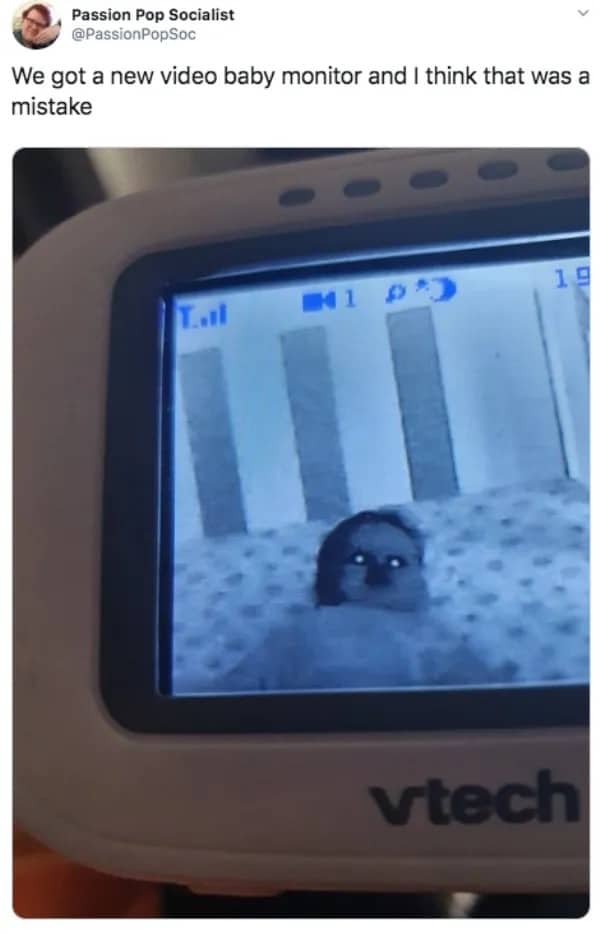 Creepy meme showing a baby looking like a demon through a glowing night-vision VTech monitor screen.