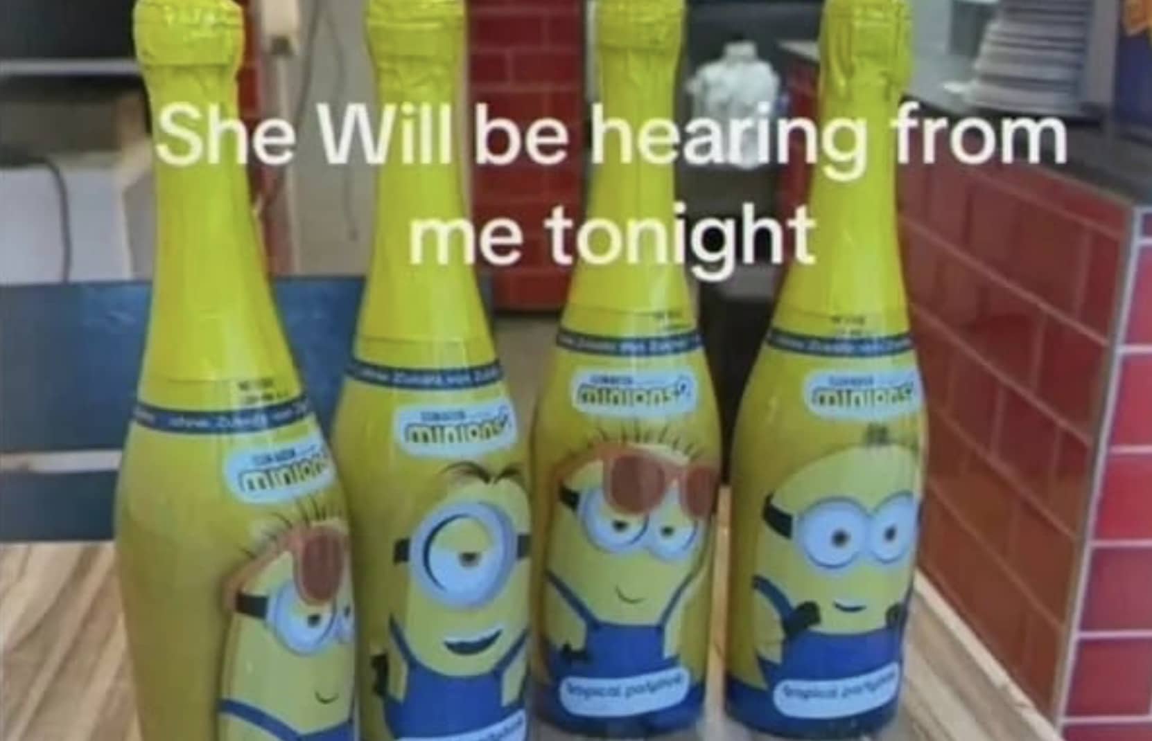 Four yellow Minion themed champagne bottles lined up with text reading she will be hearing from me tonight.