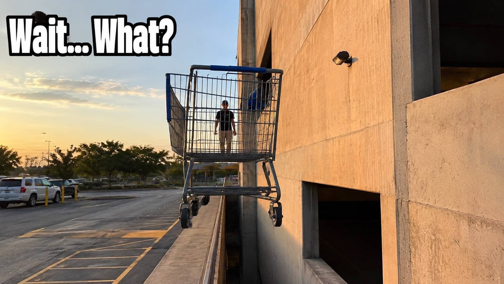Confusing perspective photo of a man standing inside a shopping cart next to a building.