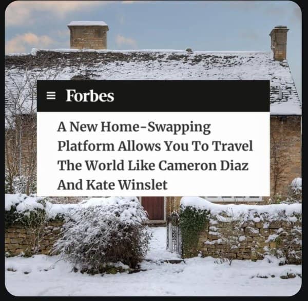 A Forbes headline about a home-swapping platform overlaid onto a snow-covered cottage.