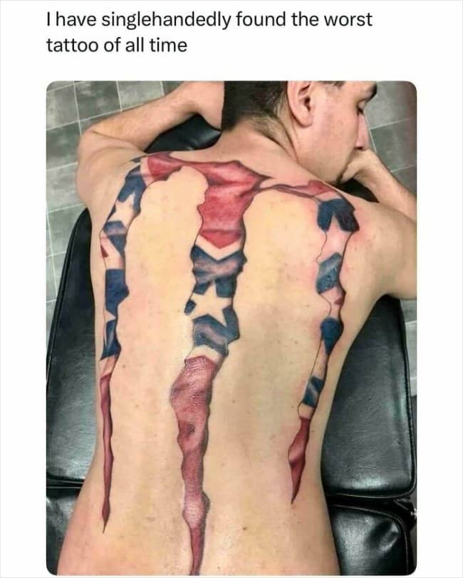 Man lying down showing a massive back tattoo of the Monster Energy claw logo filled with a confederate flag pattern.