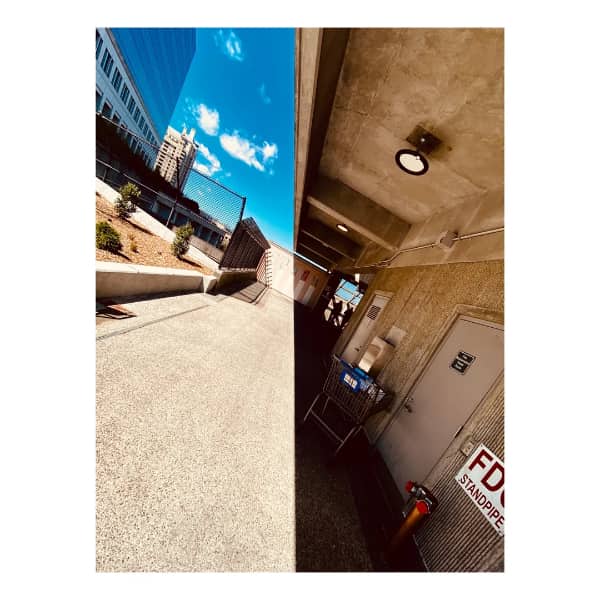 A perfectly split composition showing an outdoor city street on the left and an indoor parking garage ceiling on the right.