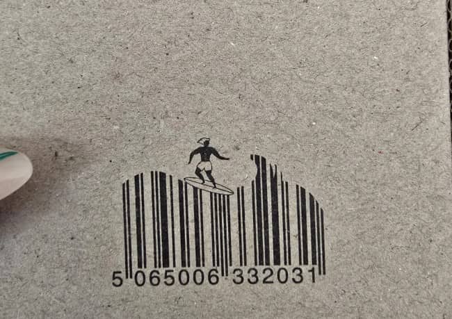 A creative barcode designed as ocean waves with a surfer riding along the vertical lines.