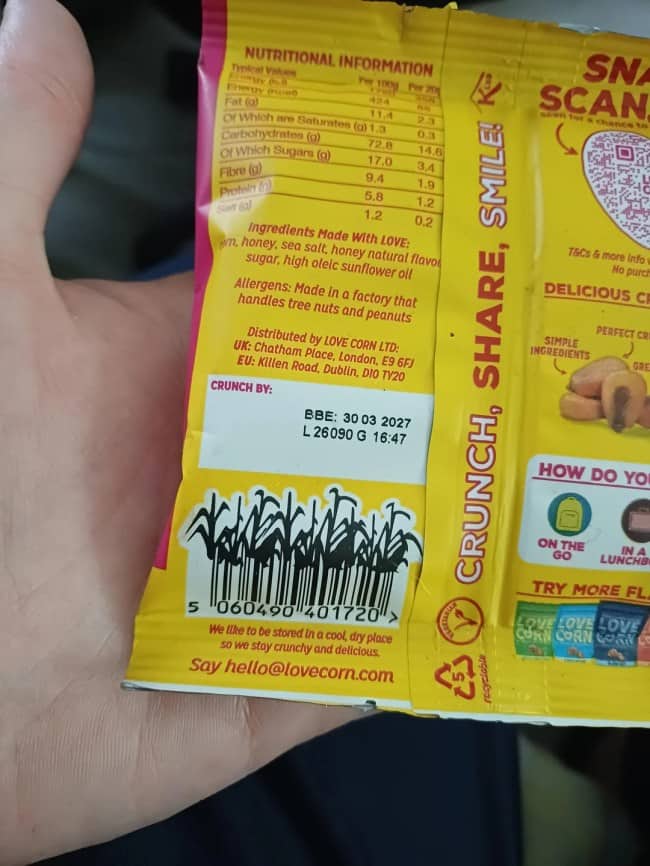 A creative barcode shaped like stalks of corn growing upward on a yellow snack package.
