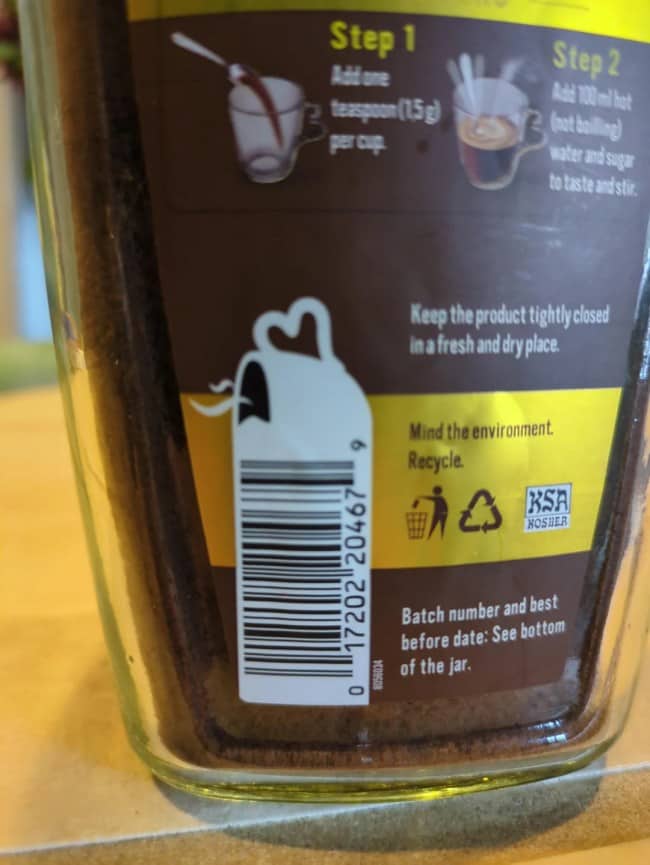A creative barcode integrated with a steaming coffee mug silhouette on a glass jar label.
