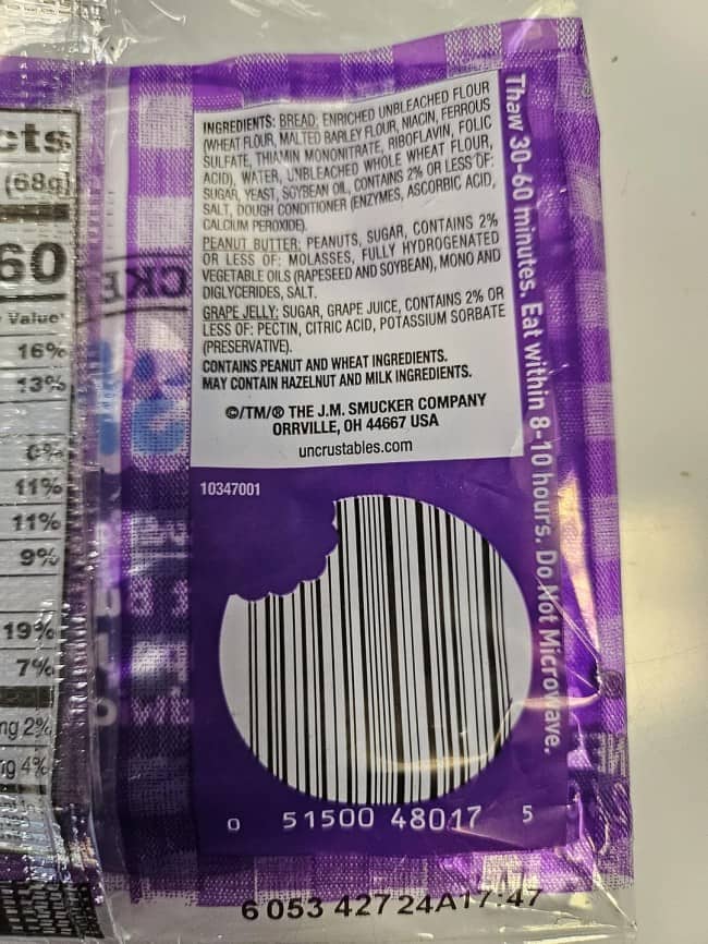 A creative barcode hidden inside the outline of a large bite taken out of an Uncrustables.