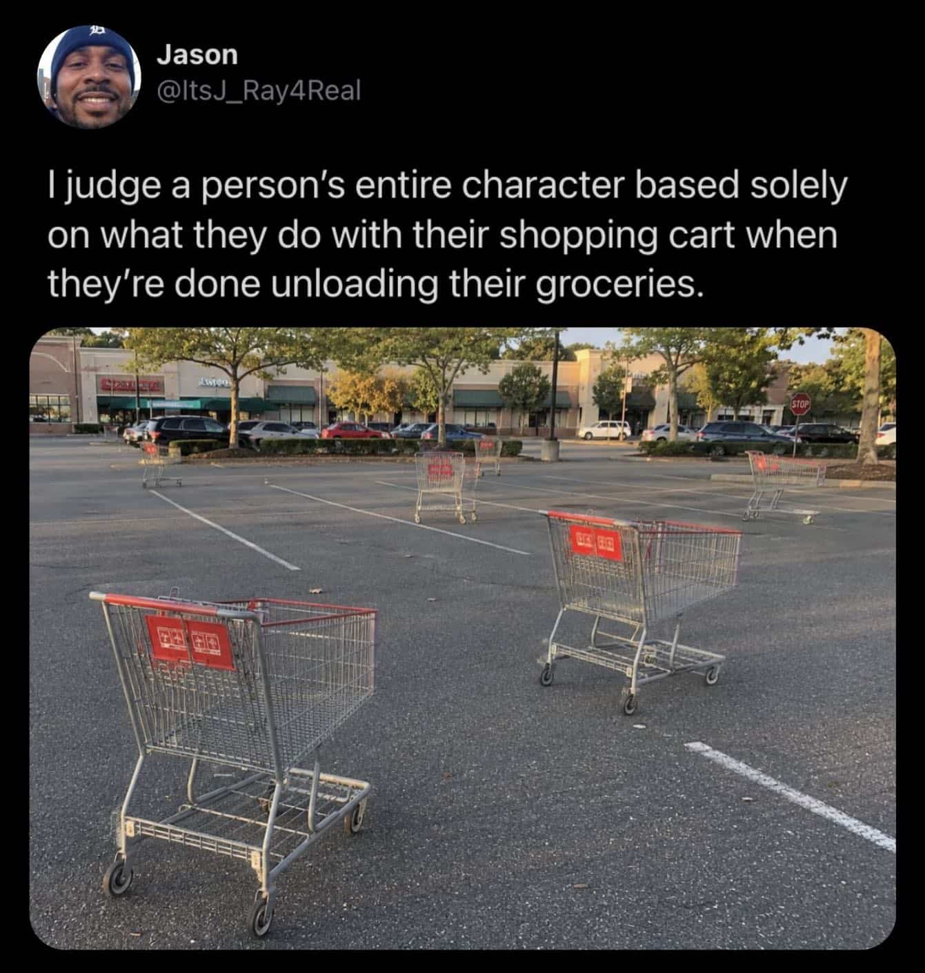 Empty parking lot filled with abandoned shopping carts left outside their proper return corrals.