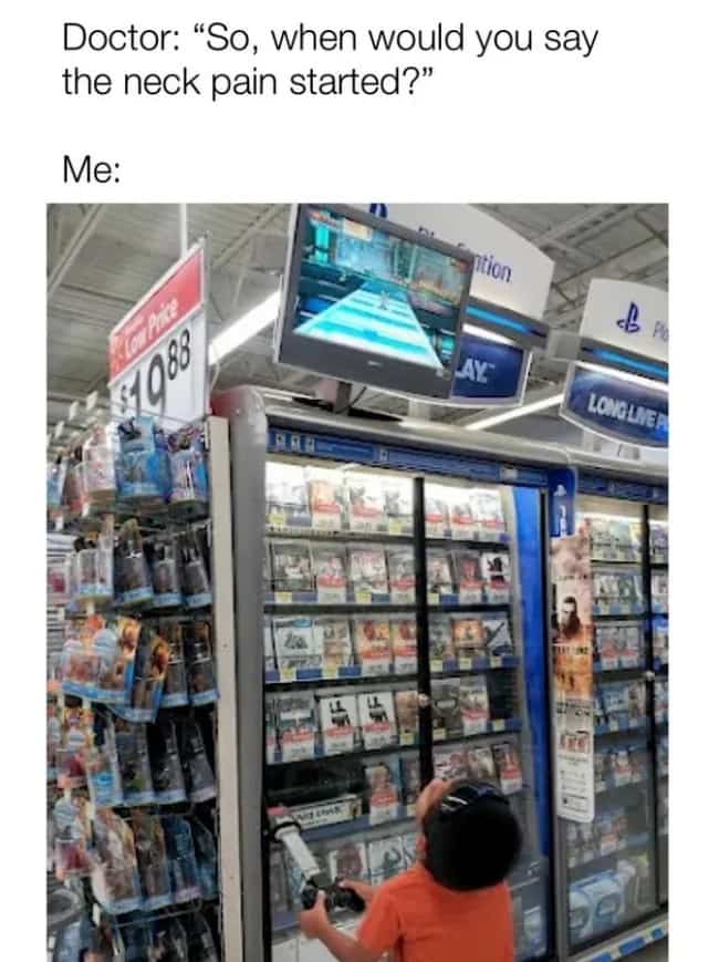 Young boy looking straight up at a high-mounted video game monitor in a retail store.