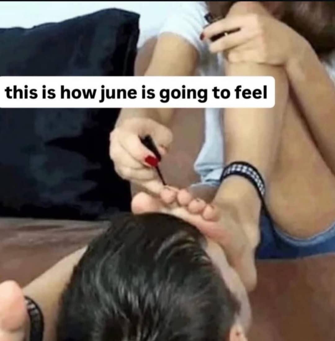 Woman painting her toenails resting on a man's head with text about June vibes.