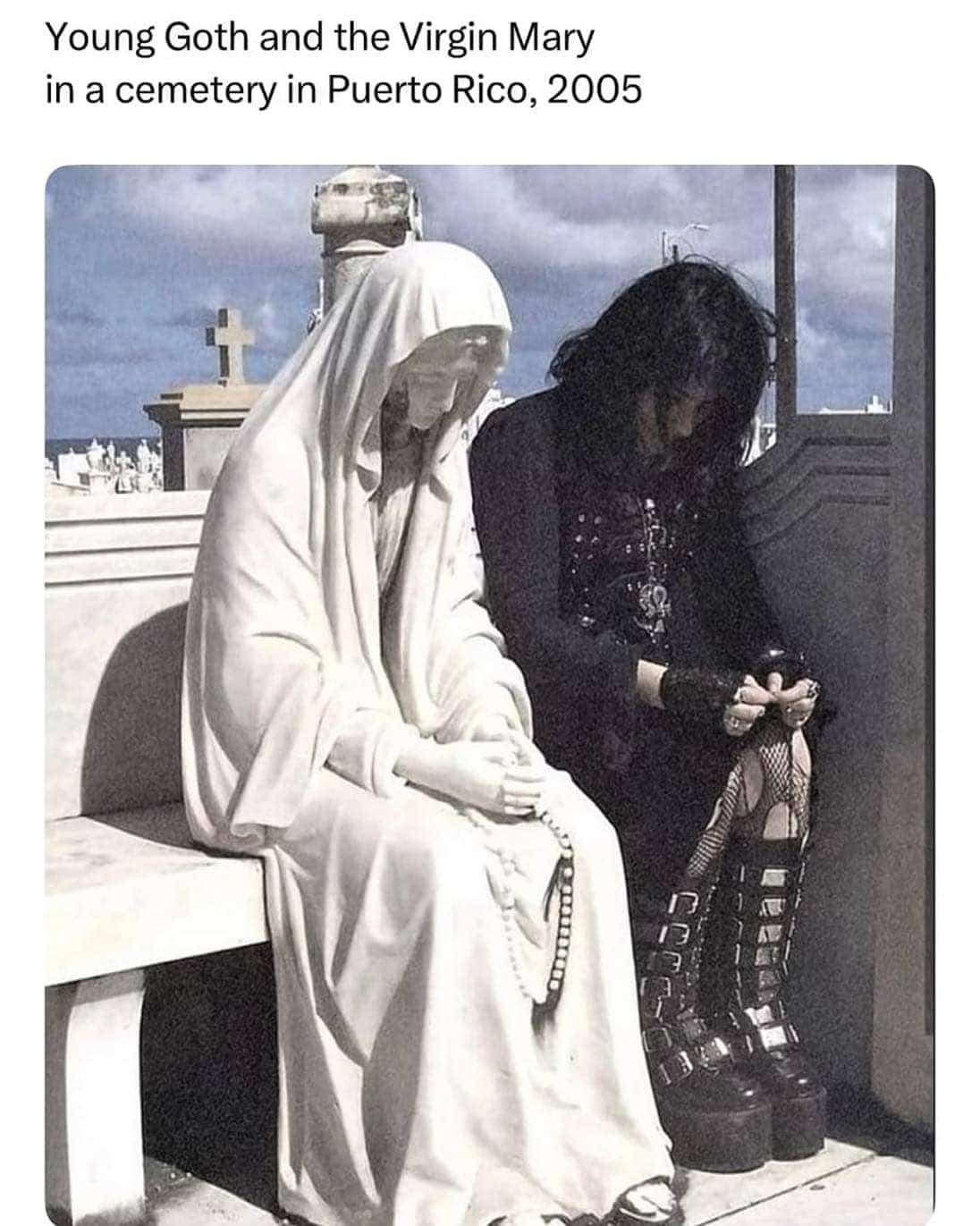 Nostalgic photograph titled young goth and the Virgin Mary sitting side by side in cemetery.