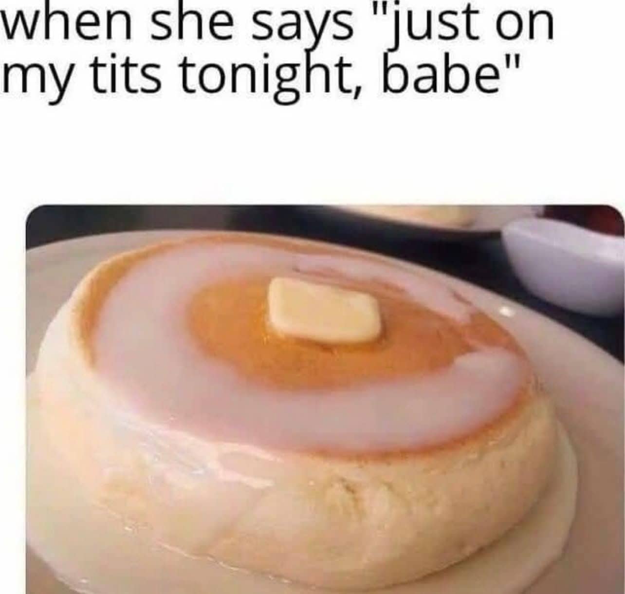 A single large pancake covered in white icing glaze and butter with a suggestive caption.