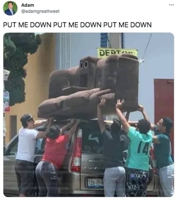 Funny street scene caption showing a group of people carrying a giant couch on foot.